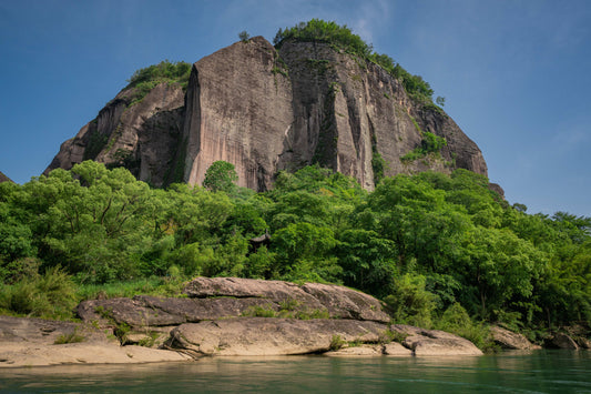 How does the local geography influence the taste of Wuyi Rock Tea?