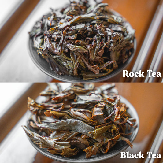 Two bowls of tea labeled 'Rock Tea' and 'Black Tea' on a wooden surface.