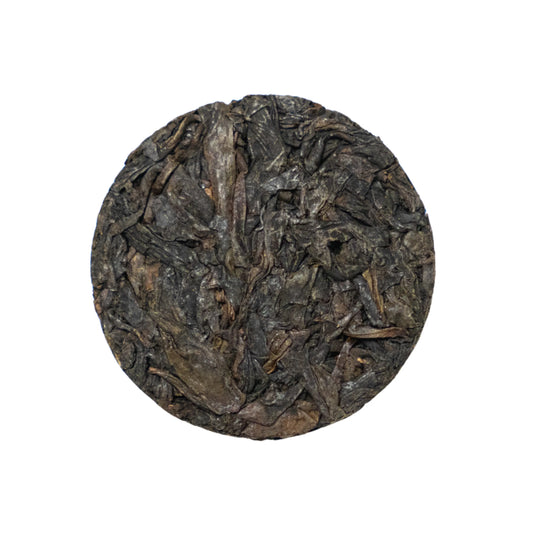 Round dark brown tea coin on a white background