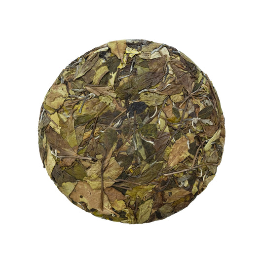 Front side of rooteas autumn dew compressed white tea cake on a white background