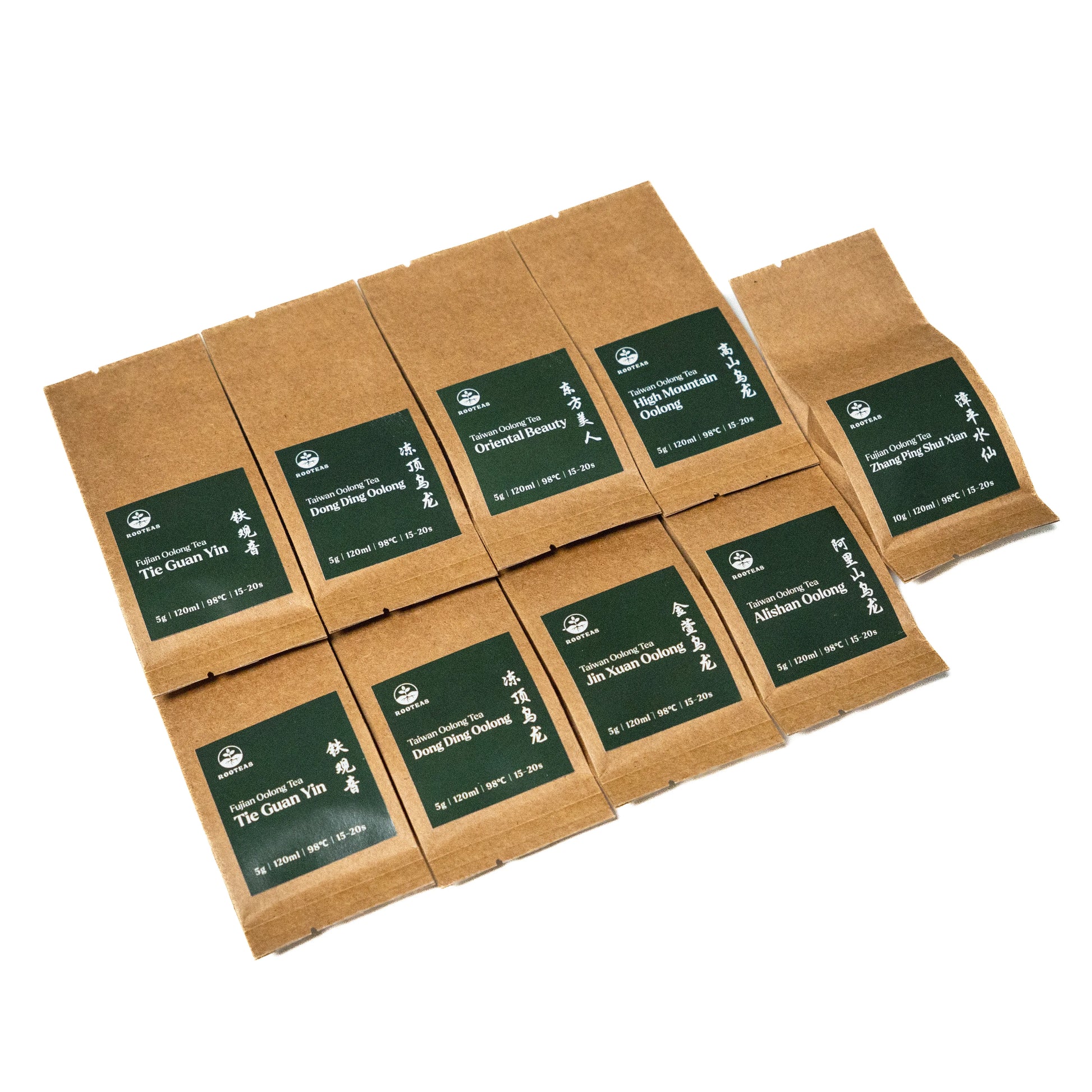 Set of brown paper tea packages with green labels on a white background