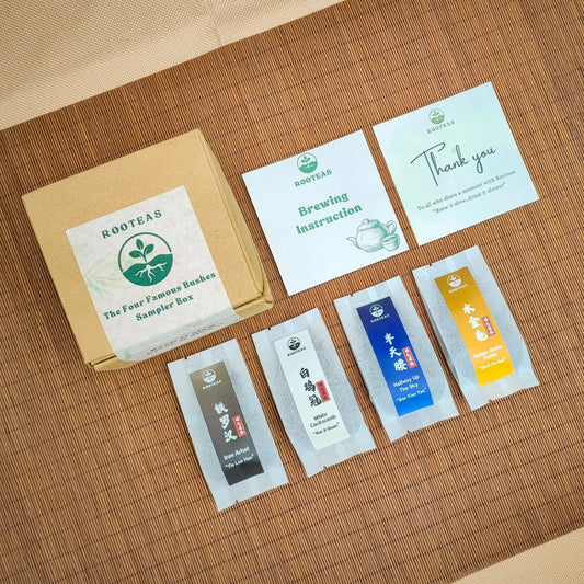 Rooteas four famous bushes of wuyi rock tea sampler set with packaging and brewing instructions on a wooden surface